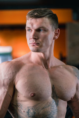 Naklejka premium athlete in the background of the gym