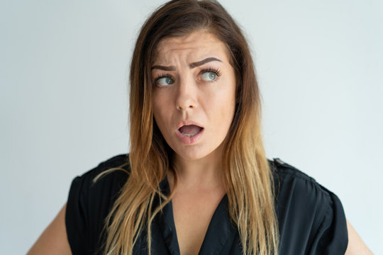 Worried pretty woman frowning and looking away. Pensive lady. Worry concept. Isolated front view on white background.