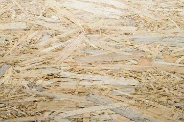 Oriented Strand Board. OSB wooden panel made of pressed sandy br
