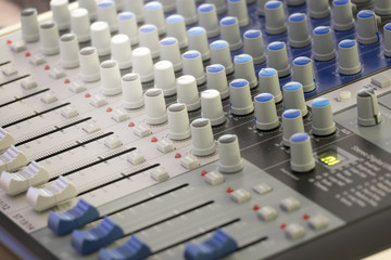 Detail with adjusting knobs on a professional audio mixer and music equipment for sound mixer...