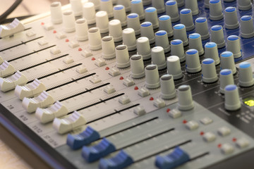 Fototapeta premium Detail with adjusting knobs on a professional audio mixer and music equipment for sound mixer control, electronic device