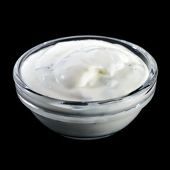 White garlic and herbs sauce in a small glass bowl isolated on b