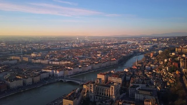 lyon city aerial view at sunrise flying from center to notre dame basilica