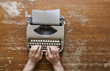 writing on vintage typwriter two hands on keyboard - obrazy, fototapety, plakaty