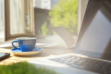 Coffee at office desk with a view from a window