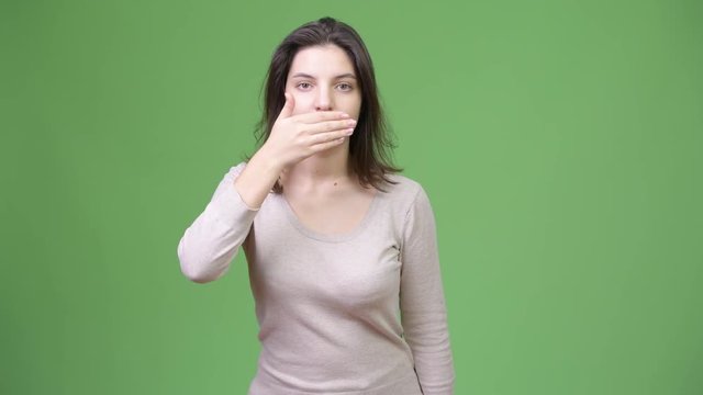 Young beautiful woman covering mouth as three wise monkeys concept