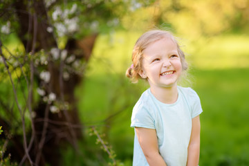 Happy toddler girl outdoors portrait in summer day