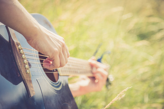 Musizieren mit Gitarre in der Wiese, Gitarrenkorpus, Hals und H&auml;nde, Freiraum