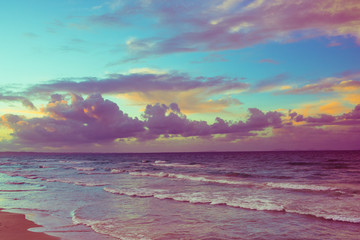 Sunset at the beach in a cloudy day