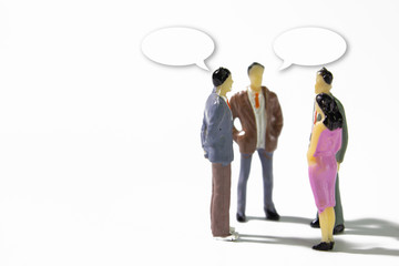 A group of miniature businessman  stand meeting on white background with text balloon.