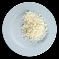 Boiled white rice in a white plate isolated on black background.