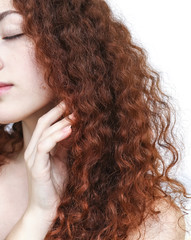 Young woman with long curly red hair Isolated on white background