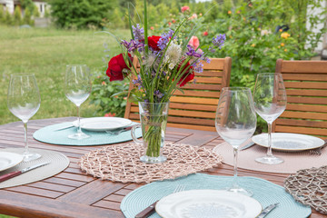Fine Banquet Table Setting With Bouquet in garden. Party concept