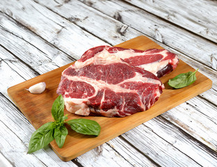 fresh raw meat on a cutting board on a wooden background
