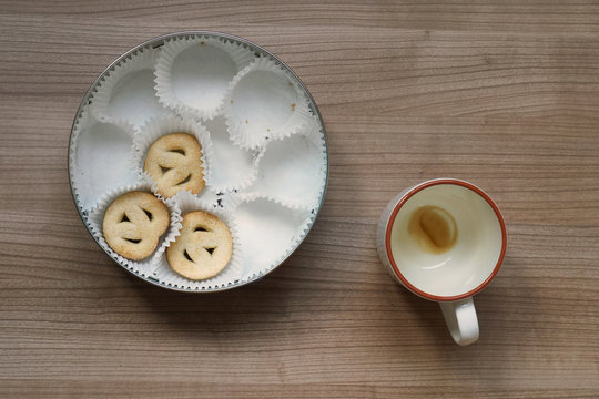 Empty Coffee Cup And Cookie Tin