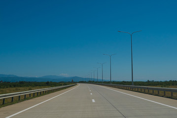Fototapeta premium Road trip view from the car asphalt and blue sky
