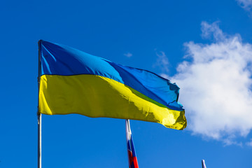 Waving national flag of Ukraine on sky background