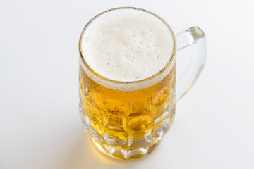 Beer mug. Mug of light fresh beer with foam and drops of water o