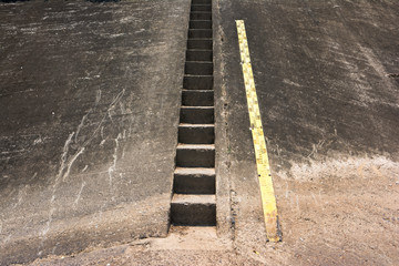 Dam concrete ladder with water level measurement background