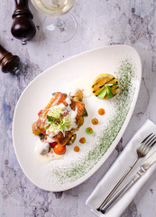 Grilled fish salmon with vegetables on a plate with white wine in a glass on background. Food restaurant menu concept.