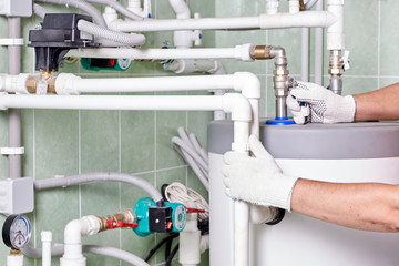 Plumber doing maintenance jobs for water and heating systems