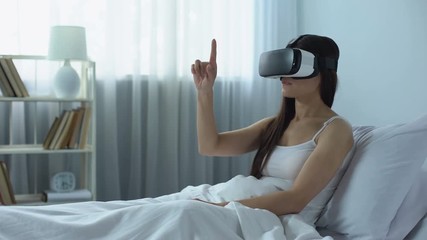 Girl surfing Internet using virtual reality headset, computer technology era