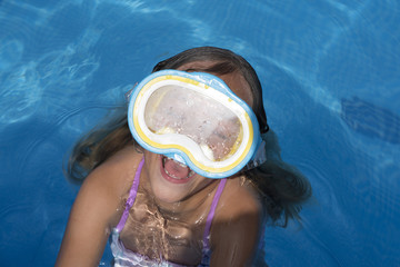 Kid in snorkel mask posing on poolside