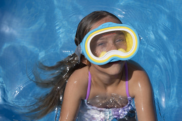 Kid in snorkel mask posing on poolside