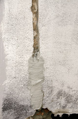 worker while splitting the concrete with the jackhammer during the renovation of a roof