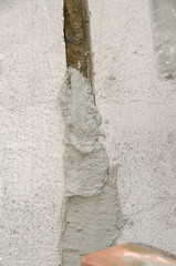 worker while splitting the concrete with the jackhammer during the renovation of a roof