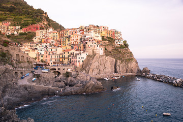 Fototapeta na wymiar Manarola - Village of Cinque Terre National Park at Coast of Italy. Beautiful colors at sunset. Province of La Spezia, Liguria, in the north of Italy - Travel destination and attractions in Europe.