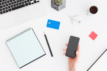 Holiday plannig. Hand with smartphone during