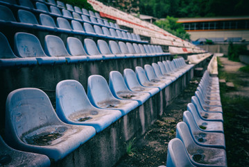 Fototapeta premium Vintage Stadium Chairs old time not used with dust blue color
