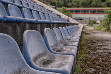 Fototapeta premium Vintage Stadium Chairs old time not used with dust blue color