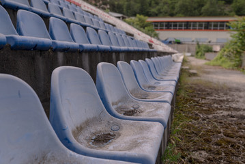 Fototapeta premium Vintage Stadium Chairs old time not used with dust blue color