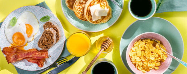 Summer breakfast - eggs, bacon, pancakes, cereal