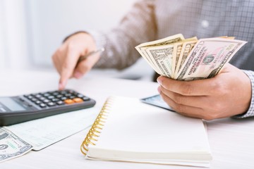 close up businessman hand using a calculator to calculate the numbers expenses accounting money...