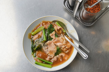 Stir fried wide rice noodles with pork and Chinese kale in gravy, Bangkok street food