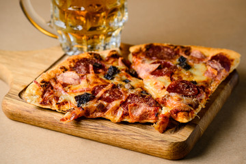 Close-up of slice of delicious homemade pizza served with light 