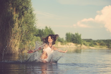 Fototapeta premium Tattooed Woman Jumping into Water