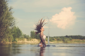 Tattooed Woman Splashing Water