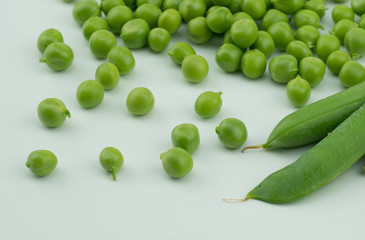 Fresh harvest green pea pods and peas from my garden on white background 