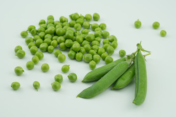 Fresh harvest green pea pods and peas from my garden on white background 