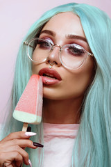 Beautiful young woman holding an ice cream, close up 