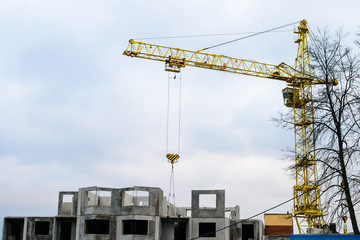 Crane and building under construction against sky