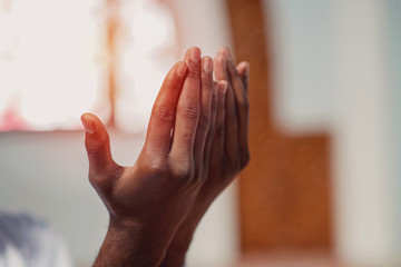 Hand of muslim black man people praying with mosque interior background