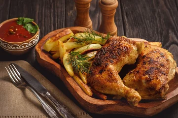 Tuinposter Roasted chicken legs with fried potatoes and tomato dip. © O.B.