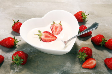 strawberry yogurt in bowl with fresh strawberries