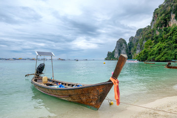 Fototapeta na wymiar Wooden long tail boat anchored on phi phi island