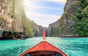 Traveling with long tail boat on fantastic emerald lagoon sea - obrazy, fototapety, plakaty